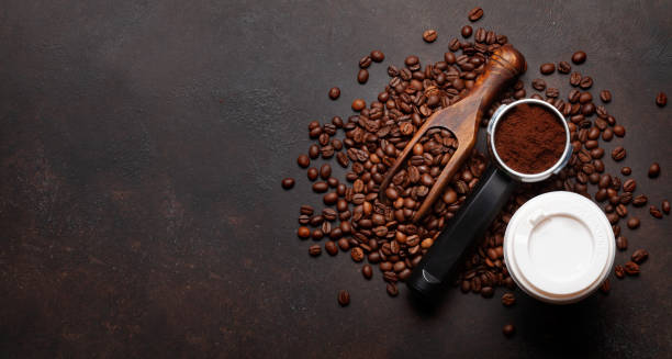 istock Roasted coffee beans and ground coffee in filter holder 1391184485