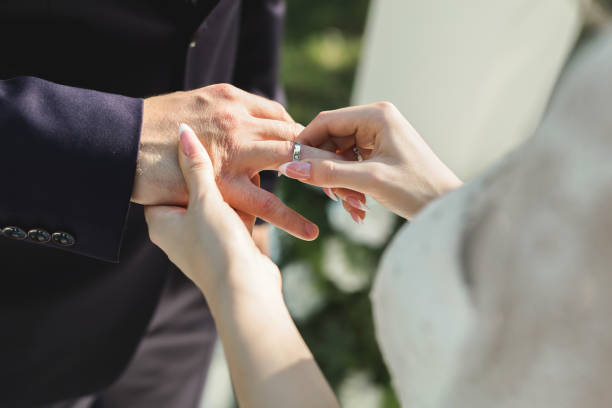 istock The bride puts a ring on the groom's finger in close-up. 1391185677