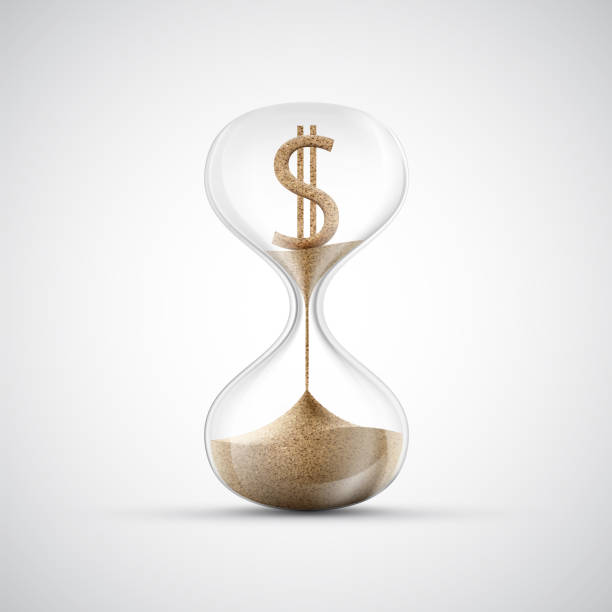 istock Dollar currency sign made of sand inside an hourglass 1391185768