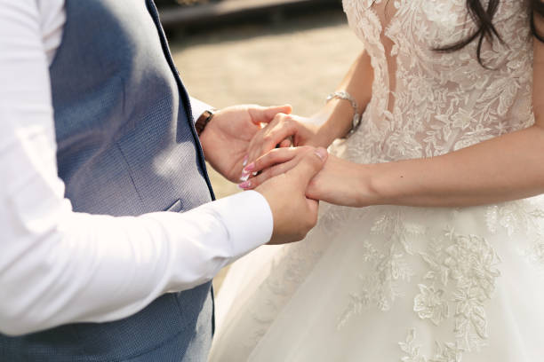 istock Bride and groom hold hands during the wedding ceremony. 1391185860