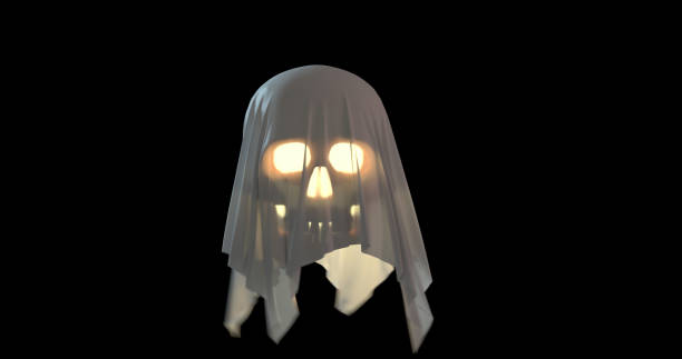 A scary Jack'O lantern with glowing eyes and mouth covered with a white sheet levitating on a black background with a copy space