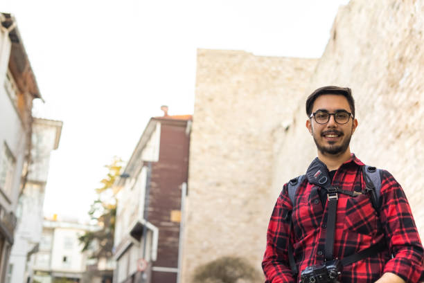 Portrait of a young man in front of the historical building stock photo