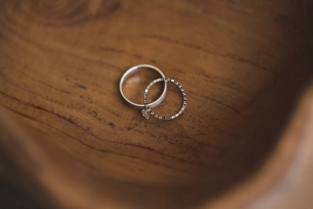 istock Wedding rings on a wooden texture close-up 1391187638