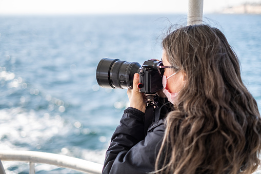 Female Photographer shooting at the boat