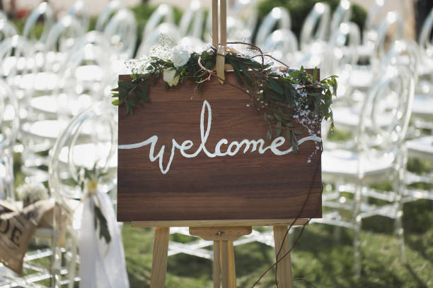 istock Romantic wedding ceremony on the beach. Sign welcome. 1391189720
