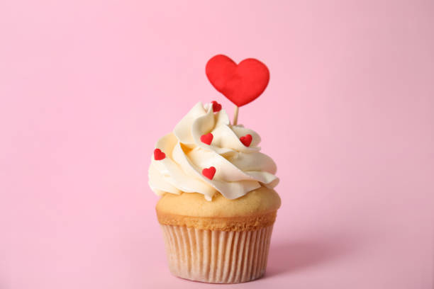 istock Tasty cupcake for Valentine's Day on pink background 1391189756