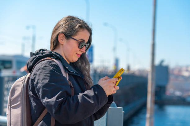 istock Female Traveller using mobile phone 1391189795