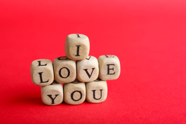 istock Cubes with words I Love You on red background. Space for text 1391190626