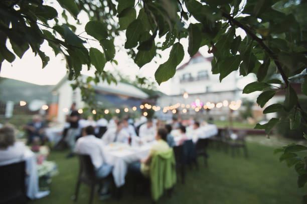 istock Wedding banquet outdoors during sunset. Tables with guests 1391190716