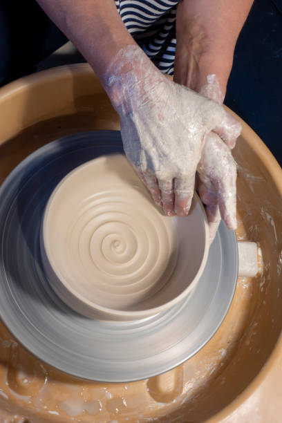 istock Close-up of hands working with clay on turntable artisan 1391190749