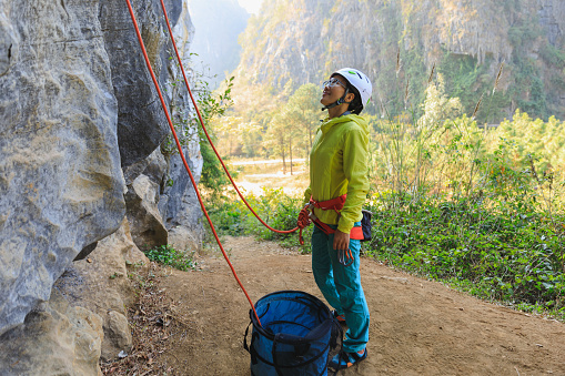 Rock climber making a eight knot