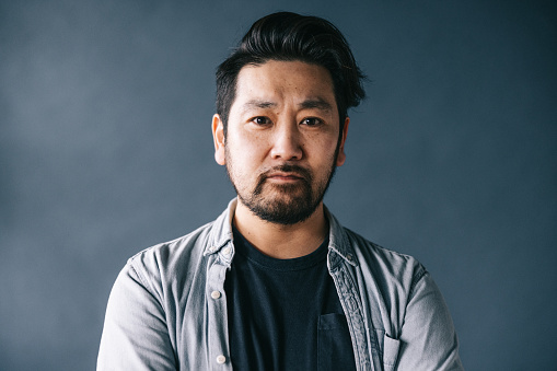 Headshot portrait of mid adult Japanese man.