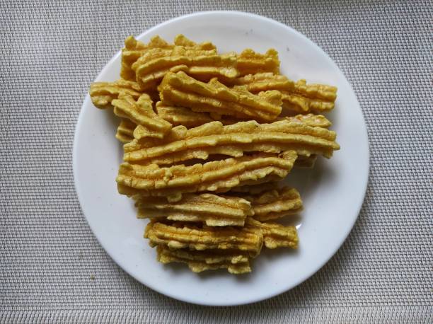 istock Traditional Indonesian crackers in root or winged form on a white plate 1391192576