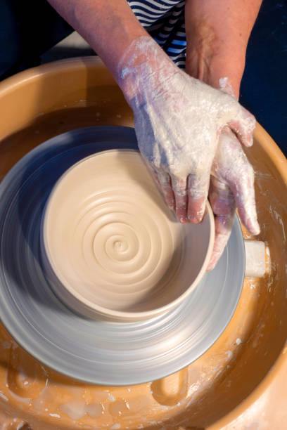istock Close-up of hands working with clay on turntable artisan 1391193135
