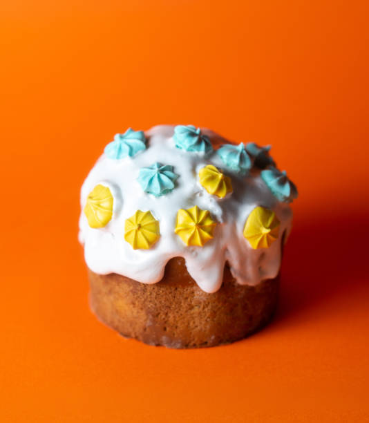 istock Concept of tasty Easter food, Easter cake on orange background 1391193151