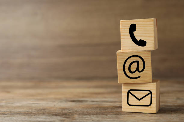 istock Hotline service. Cubes with icons on wooden background, space for text 1391196210