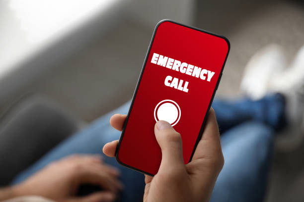 istock Hotline service. Man making emergency call via smartphone indoors, closeup 1391196329