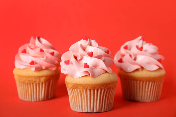 istock Tasty cupcakes for Valentine's Day on red background 1391197460