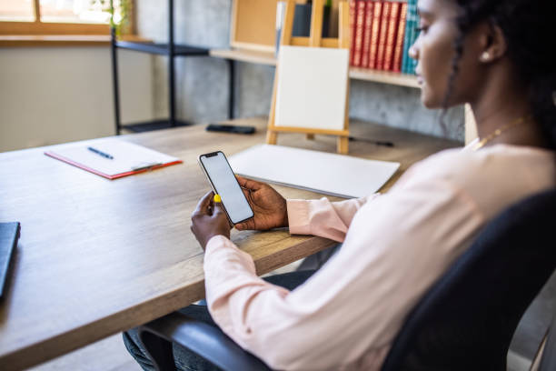 istock Modern female teacher Black ethnicity using mobile phone for digital banking 1391197548