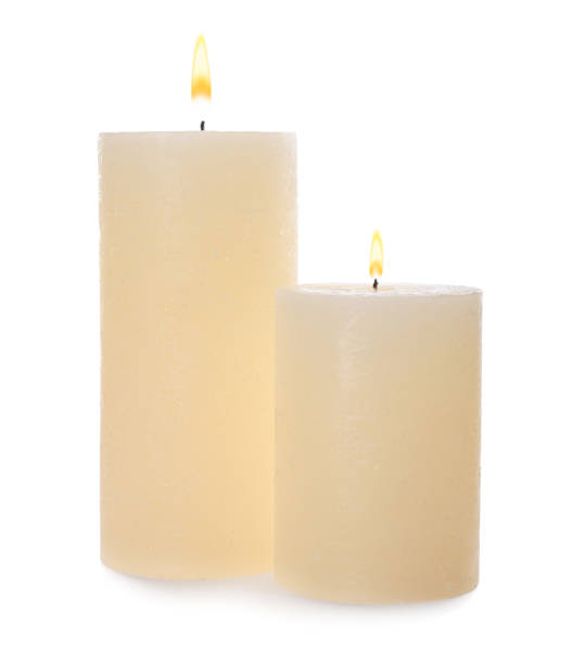 istock Two pillar wax candles isolated on white 1391197604