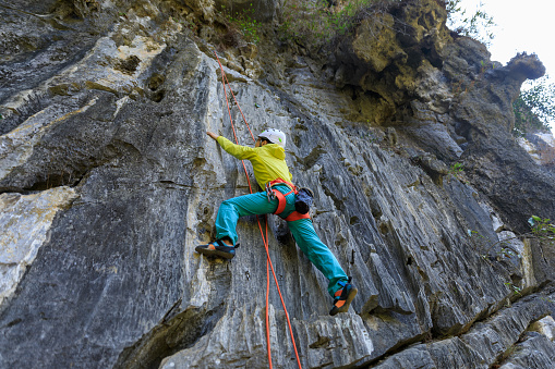 Female rock climber on the cliff