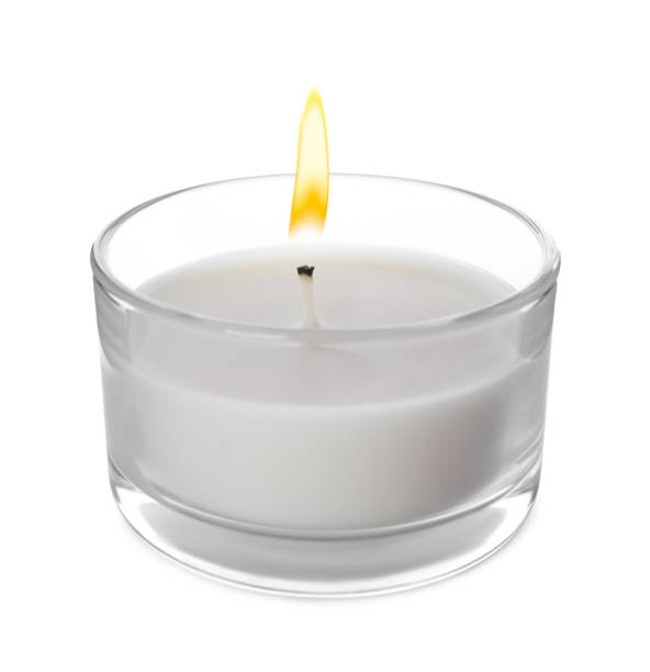 istock Small wax candle in glass holder isolated on white 1391198337