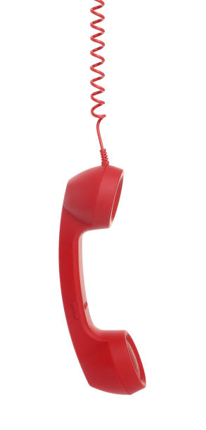istock Red corded telephone handset hanging on white background. Hotline concept 1391198841