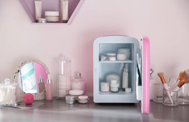 istock Mini fridge with cosmetic products on grey vanity table indoors 1391199689