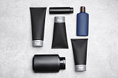 Flat lay composition with set of men's cosmetic products on light grey background