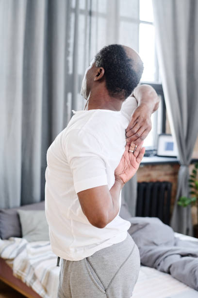 istock African American elderly man doing stretching exercise for spinal cord 1391199835