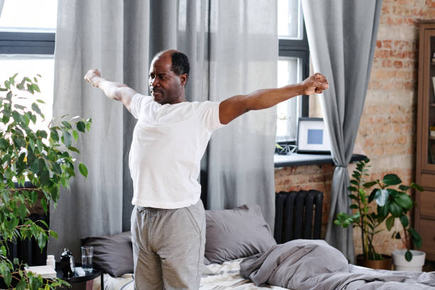 istock Active elderly black man with outstretched arms exercising in the morning 1391199855
