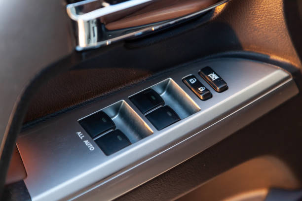 istock Close-up of the side door buttons: window adjustment buttons, door lock. window control panel in a modern car. Automatic car window controls and details. Selective focus. 1391200414