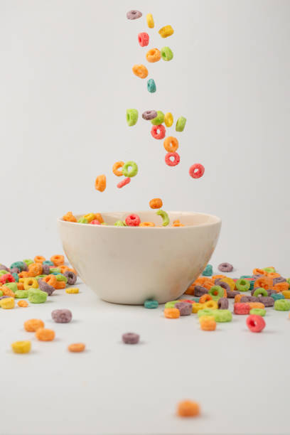 istock Colorful cereal box for morning breakfast. Corn flakes falling to the white bowl. Motion. 1391207440
