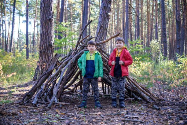 istock Two sibling brothers boys In the spring or autumn pine forest pl 1391207600