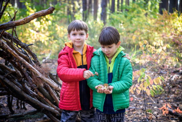 istock Two sibling brothers boys in the spring or autumn pine forest pl 1391207617
