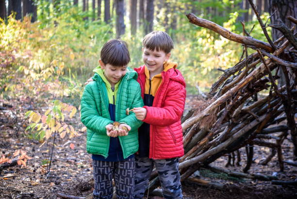 istock Two sibling brothers boys in the spring or autumn pine forest pl 1391207635