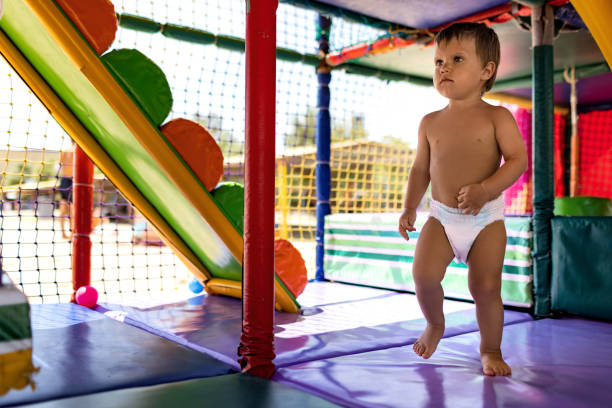 istock Boy in diaper with ball playing in playroom on weekend 1391211657