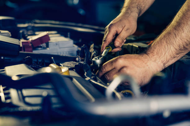 istock Auto mechanic working on car engine in mechanics garage. 1391212539