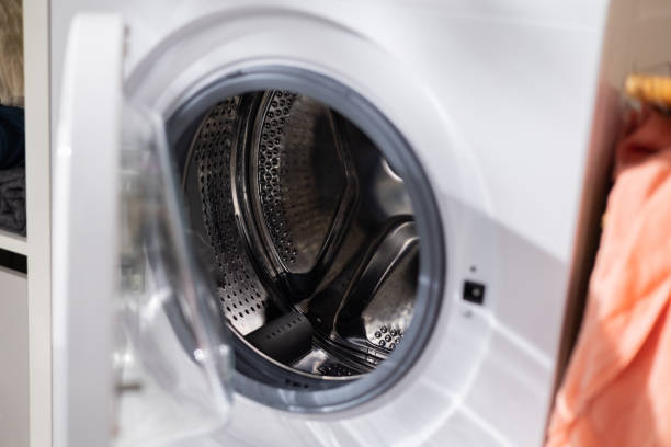istock Open washing machine door, empty drum, clean interior, laundry room 1391212801