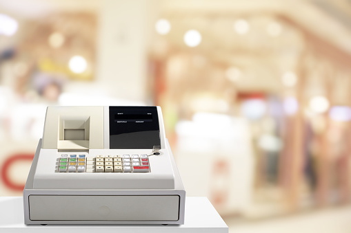 Electronic cash register has backdrop of a clothing store