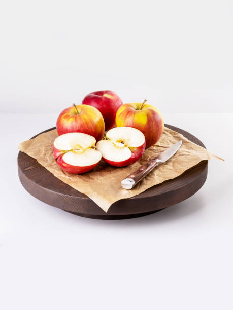 istock Group of red apple on wooden board on grey background. Vertical image. 1391213084