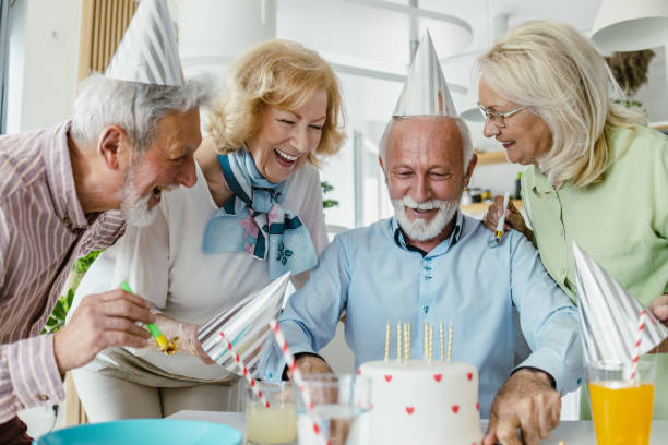 istock Senior man celebrating birthday with friends 1391214843