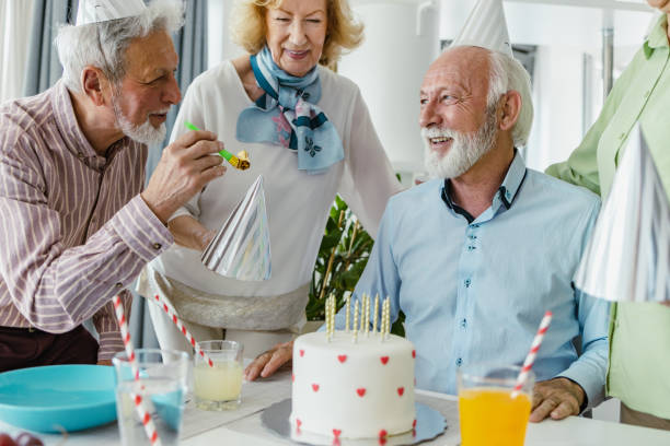 istock Senior man celebrating birthday with friends 1391214893