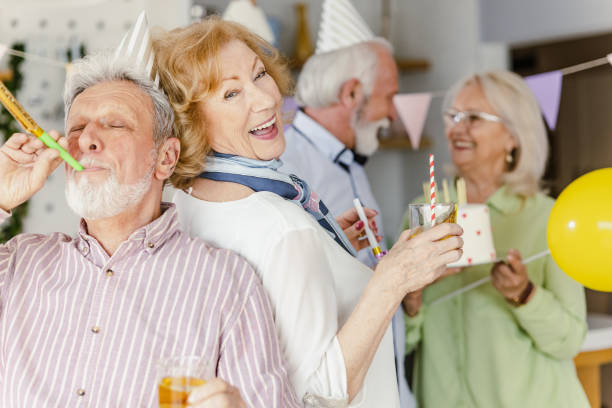 Cheerful senior group having great time on a birthday party