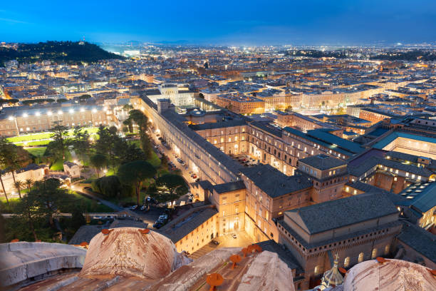 View over Vatican City surrounded by Rome, Italy at night.