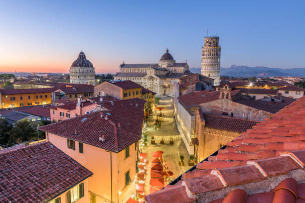 Pisa, Italy with the Duomo and Leaning Tower Pisa, Italy with the Duomo and Leaning Tower at dusk. pisa stock pictures, royalty-free photos & images