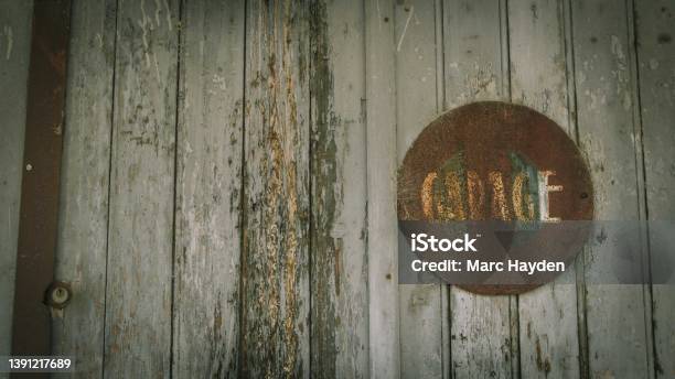 Old Worn Wooden Door With Garage Sign Stock Photo - Download Image Now - Garage, Retro Style, Old-fashioned
