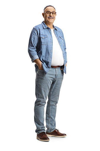Full length portrait of a mature man wearing a denim shirt and jeans isolated on white background