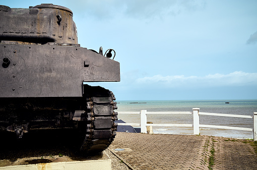 World War 2 Sherman tank at a public carpark overlooking the coastal village of Arromanches les Bains in Normandy, France.
