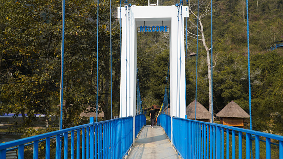 Tourist walk on the Blue bridge at Vang Vieng, Laos.